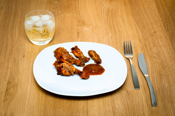 Peri-peri chicken on a white plate on a table
