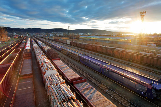 Railway at sunset with cargo trains.