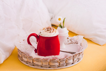 Hot chocolate with whipped cream and little flower in eggshell.