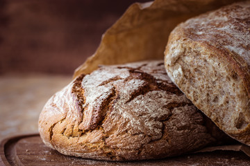 rustic rye bread on wooden board. Selective focus.