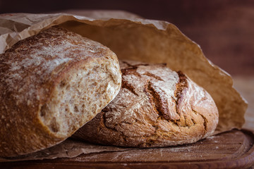 rustic rye bread on wooden board. Selective focus.