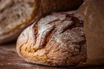 rustic rye bread on wooden board. Selective focus.