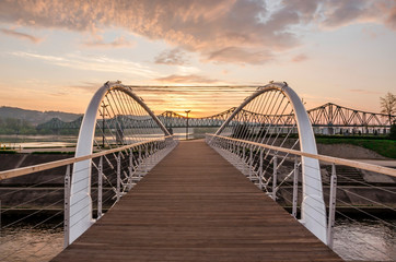 Fototapeta na wymiar Footbridge on Zglowiaczka in Wloclawek at sunrise
