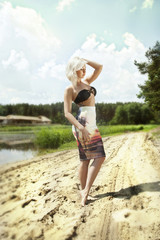 Blonde woman posing outdoor in summer