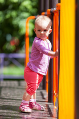 Small infant standing in playground