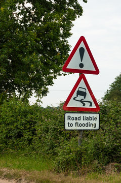 Road liable to flooding warning sign on countryside road