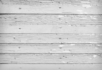 Fototapeta premium Weathered wood background with peeling white paint features horizontal distressed planks in monochrome tones for rustic backdrop design, vintage overlay, or surface texture mockup