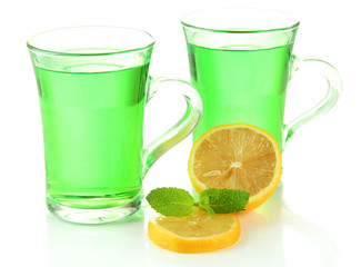 Two transparent cups of green tea and lemon isolated on white