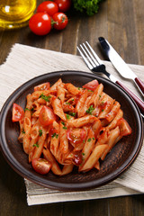 Pasta with tomato sauce on plate on table close-up