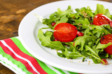 Green salad made with  arugula, tomatoes and sesame