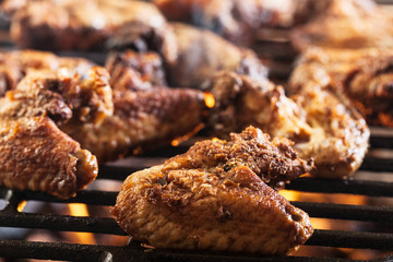 Grilling chicken wings on barbecue grill