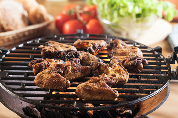 Grilling chicken wings on barbecue grill