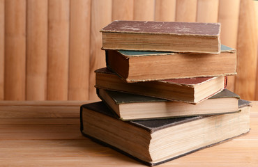 Old books on table on wooden background