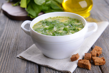 Delicious green soup with sorrel on table close-up