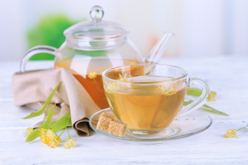 Tasty herbal tea with linden flowers on wooden table