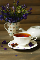 Obraz na płótnie Canvas Cup of fresh herbal tea on wooden table