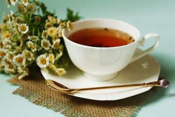 Cup of fresh herbal tea on table