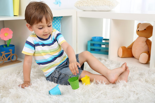 Cute Little Boy Playing In Room