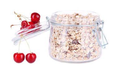 Homemade granola in glass jar and fresh berries, isolated