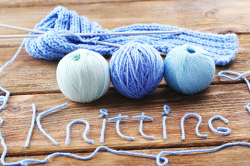 Yarns for knitting on wooden table close-up