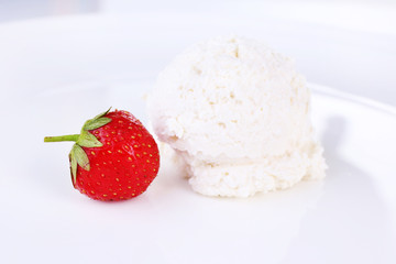 Vanilla ice cream balls on plate, isolated on white