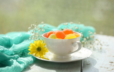 Jelly candies in cup on table close-up