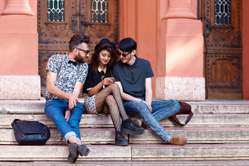friends having fun together on stairs of university