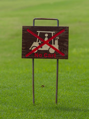 No cart sign on green at a golf course.