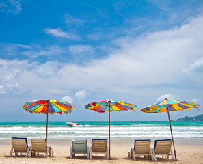 Fototapeta na wymiar Beach chairs and colorful umbrella on the beach at Phuket Thaila