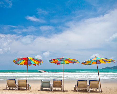 Beach chairs and colorful umbrella on the beach at Phuket Thaila