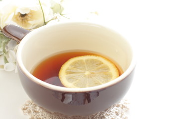 Lemon tea with flower on background