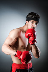 Muscular boxer wiith red gloves