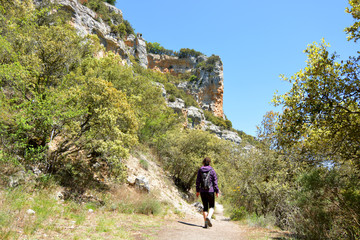 mujer caminando por un camino entre rocas