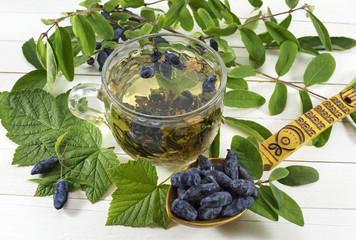 Summer tea with berries in spoon