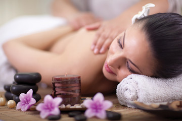Beautiful woman having a wellness back massage at spa salon
