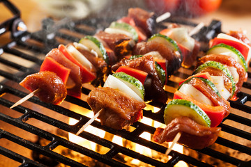 Grilling shashlik on barbecue grill
