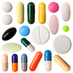 Pills and capsules on white background