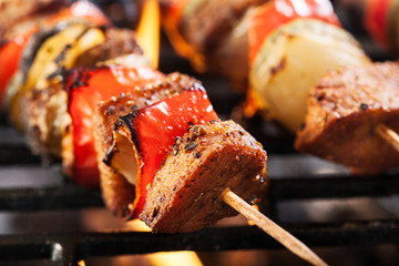 Grilling shashlik on barbecue grill