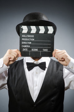Funny man with movie clapper board