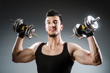 Muscular ripped bodybuilder with dumbbells