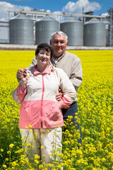 Elderly couple on rapeseed field