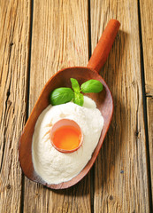 Flour and fresh egg in a scoop