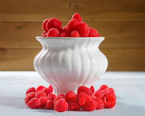 Ripe raspberries on a wooden background