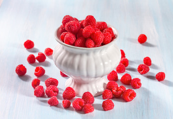 Ripe raspberries on a wooden background