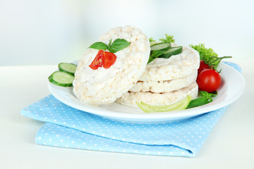 Tasty crispbreads with vegetables on white table