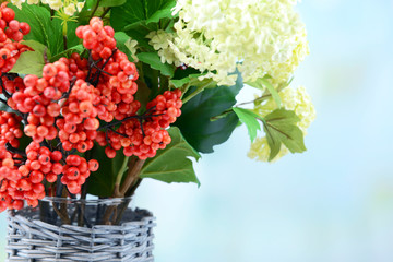 Flowers and berries in vase,