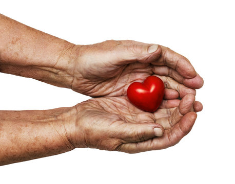 elderly woman keeping red heart in her palms