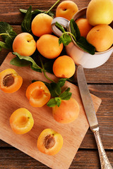 Ripe apricots with green mint leaves