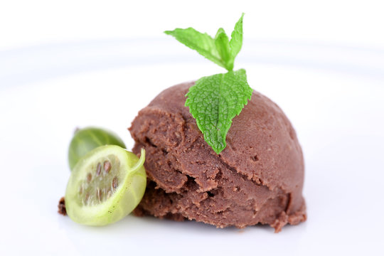 Chocolate ice cream with mint leaf and gooseberry, isolated