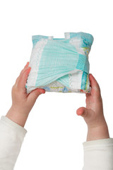 Baby's hands hold dirty diapers, isolated on white